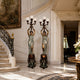 Large Classical Draped Goddess Candelabra Bronze Sculpture, 250cm pair with globe lamps on carved pedestals, displayed near a staircase in an entryway.