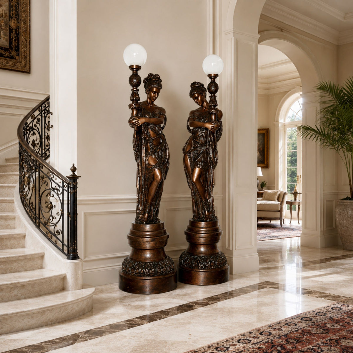 Large Classical Goddess Torchère Bronze Sculpture, 240cm pair with globe lamp posts, flanking a curved staircase in a marble-floored foyer.