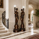 Large Classical Goddess Torchère Bronze Sculpture, 240cm pair with globe lamp posts, flanking a curved staircase in a marble-floored foyer.