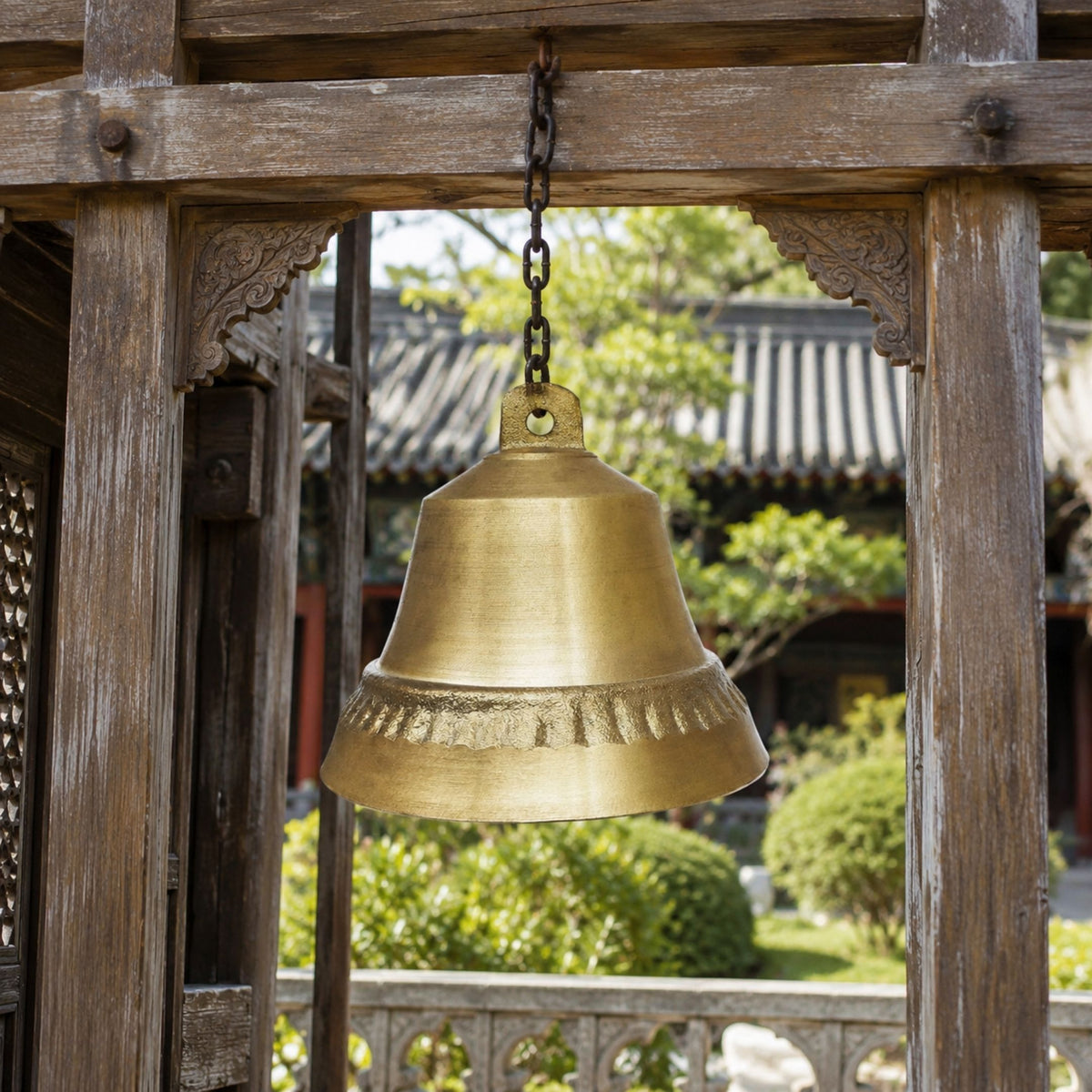 Large Traditional Hanging Bell Bronze Sculpture, 120cm, gold cast bronze bell suspended by chain from a wooden pavilion beam with garden view beyond.