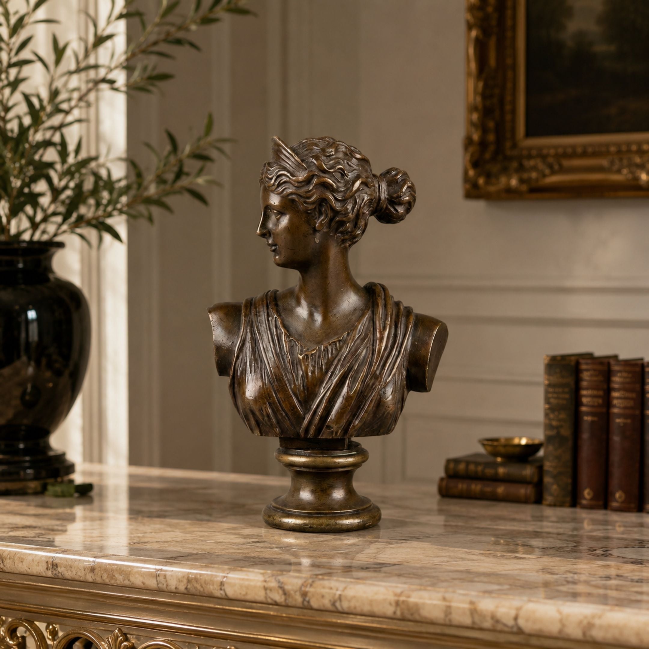 Classical Female Bust Bronze Bust, 50cm, shown in profile with upswept hair on a marble console beside books and a gilt-framed painting.