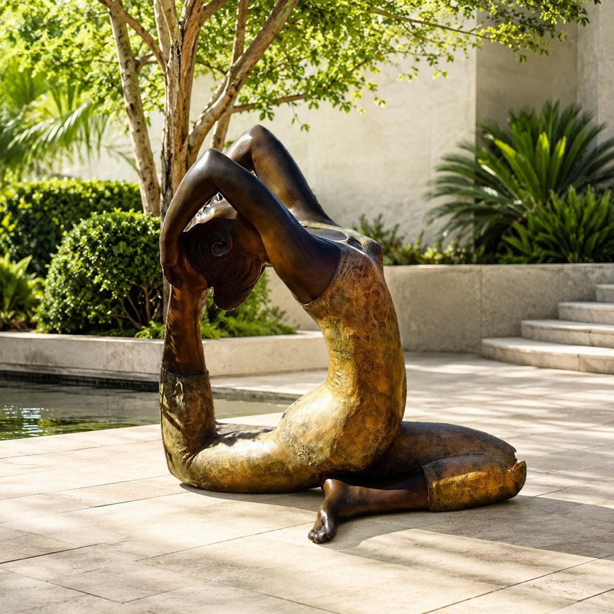Life-Size Contemporary Backbend Figure Bronze Sculpture, 200cm, bronze nude figure arched in a deep backbend, set outdoors on a stone patio near greenery and a pool.