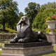 Monumental Classical Egyptian Sphinx Bronze Sculpture, 200cm, dark bronze finish, recumbent lion form with nemes headdress, on stone base in a garden setting.