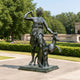 Life-Size Classical Goddess and Deer Bronze Sculpture, 250cm, showing the robed goddess with arm raised beside a bounding deer, on a stone base in a garden courtyard.