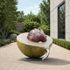 Monumental Contemporary Halved Avocado Bronze Sculpture, 220cm, in olive-gold and dark red multi-tone patina, displayed outdoors on a paved courtyard near trees and a modern building facade.
