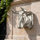 Classical Bull Head Bronze Relief - 70cm in silver-toned metal, mounted on a stone wall with curved horns and collar detail, ivy visible nearby.