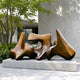Large Modern Abstract Bronze Sculpture, 94cm, with three interlocking biomorphic forms on a concrete plinth, shown outdoors near trees and a concrete wall.