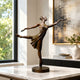 Contemporary Ballerina en Pointe Bronze Sculpture, 60cm, on a round base on a marble table with a window and framed art in a living room.