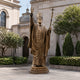 Life-Size Traditional Standing Pope Bronze Statue, 400cm, in bronze with mitre and cross-topped staff, raised hand, on a stepped base outside a stone cathedral courtyard.