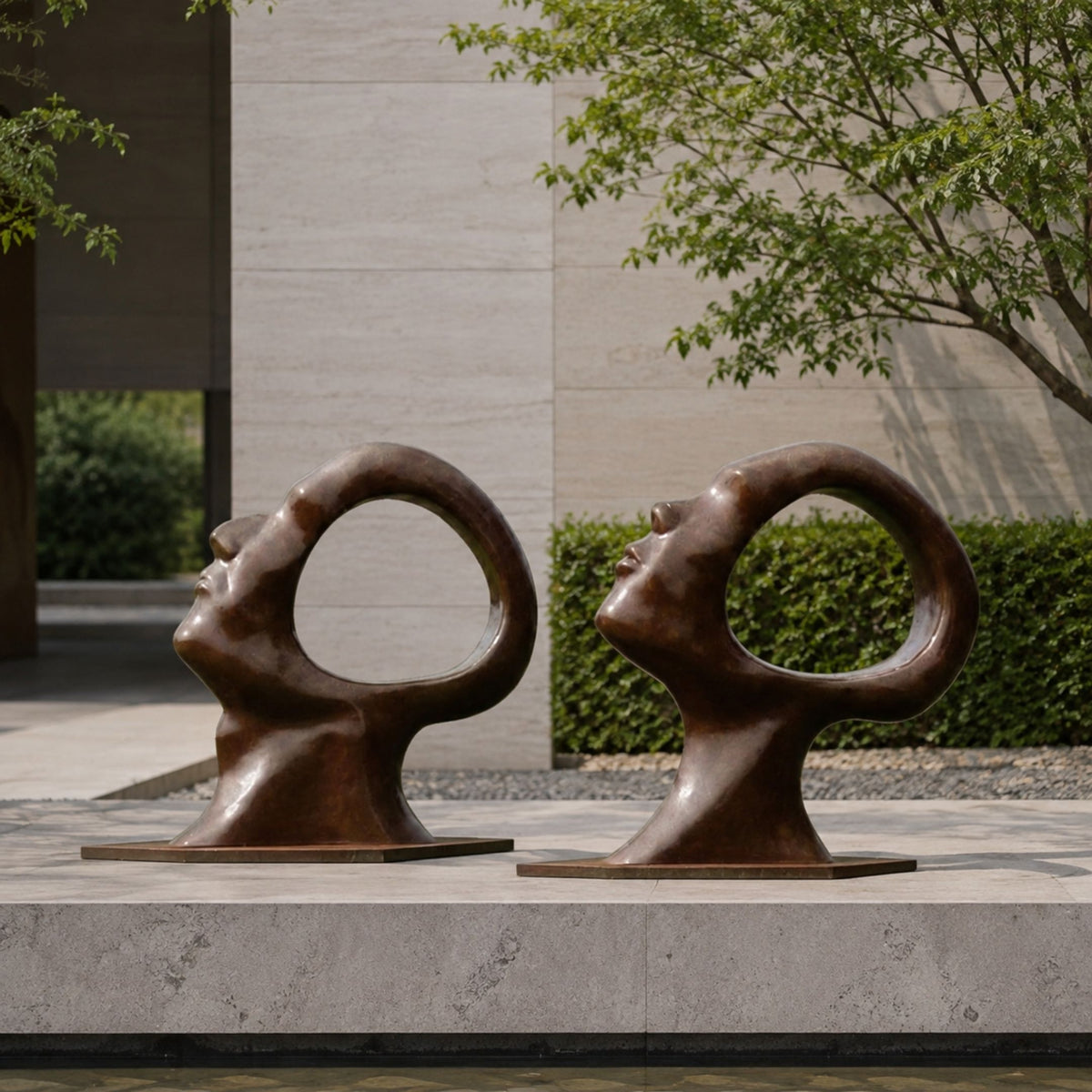 Large Contemporary Abstract Face Bronze Sculpture, 150cm, pair of tilted heads with circular voids, on flagstone terrace near hedges and trees.