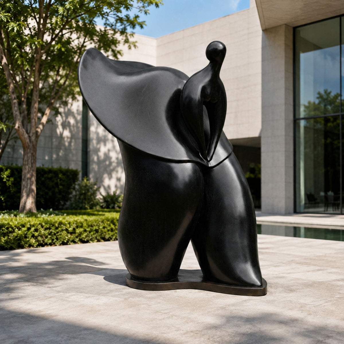 Monumental Contemporary Abstract Female Figure Bronze Sculpture, 220cm, black finish with wide sweeping upper form, displayed on a patio near a modern building.