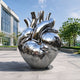Monumental Contemporary Anatomical Heart Bronze Sculpture, 300cm, mirror-polished metal with branching vessels, displayed outdoors reflecting nearby buildings and trees.