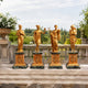 Classical Four Seasons Goddesses Bronze Sculpture Set, 40cm gilded figures on marble bases, displayed outdoors on a stone balustrade with greenery beyond.