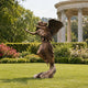 Life-Size Classical Winged Angel Bronze Sculpture, 200cm, depicting an angel carrying a child with outstretched wings, displayed on a lawn near a garden pavilion.