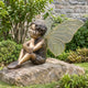 Traditional Fairy Boy Child Bronze Sculpture, 150cm, seated figure with hands to face and large golden-veined wings, set on a garden stone.