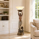 Classical Mermaid Floor Lamp Bronze Sculpture, 120cm, holding an illuminated shell shade overhead, shown in a living room beside a bookshelf and sofa.