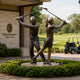Life-Size Contemporary Golfer Duo Bronze Sculpture by Giant Sculptures, male and female figures back-to-back mid-swing, displayed outside Greenfield Golf Club.