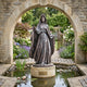 Giant Sculptures Life-Size Virgin Mary Queen of Heaven Bronze Statue 280cm with starry halo and crown, arms outstretched, on a plinth beside a lily pond under a stone arch.