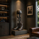Traditional Battle Cross Memorial Bronze Sculpture by Giant Sculptures displayed on a grey plinth in a study beside a folded flag case and framed artwork.