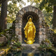 Life-Size Classical Virgin Mary Standing on Crescent Moon Bronze Statue by Giant Sculptures in gold finish, set within a mossy stone arch beside a pond.