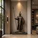 Life-Size Classical Spartan Warrior Bronze Statue by Giant Sculptures displayed in a modern entrance hall, holding a raised spear and round shield on a stone plinth.