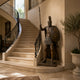 Giant Sculptures Monumental Classical Spartan Warrior Bronze Sculpture 250cm with spear and shield, displayed beside a curved staircase in a stone entrance hall.