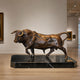 Giant Sculptures Large Traditional Striding Bull Bronze Sculpture on a black marble base, shown mid-stride in a gallery with framed paintings nearby.