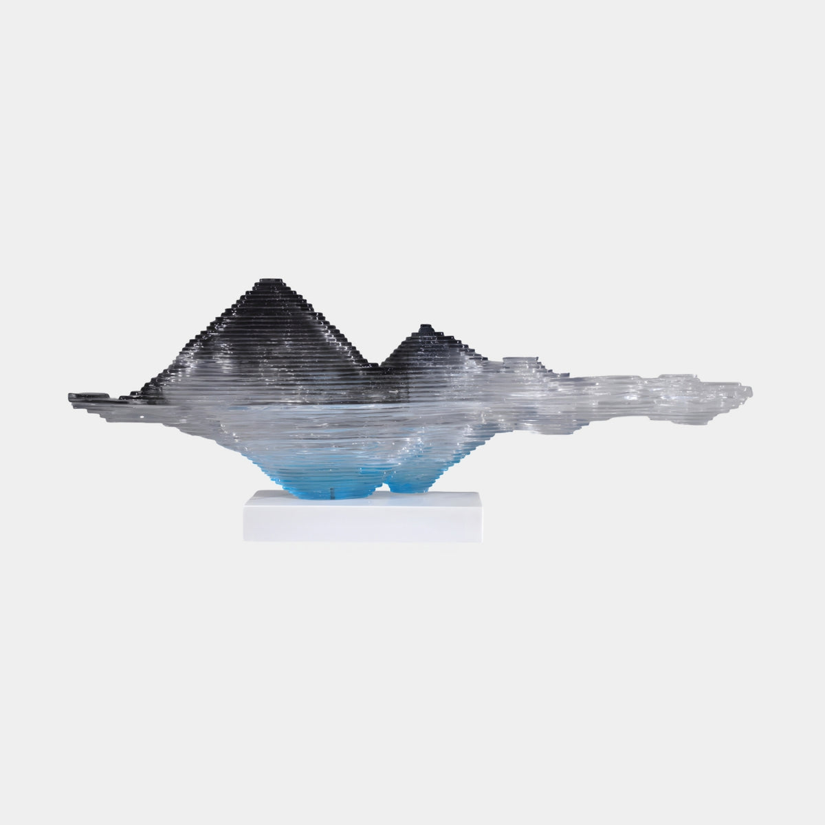Clear Layered Peak & Reflection Resin Sculpture, 117cm, smoke-dark mountain peaks fading to blue reflection, layered resin on white marble base, plain light background.