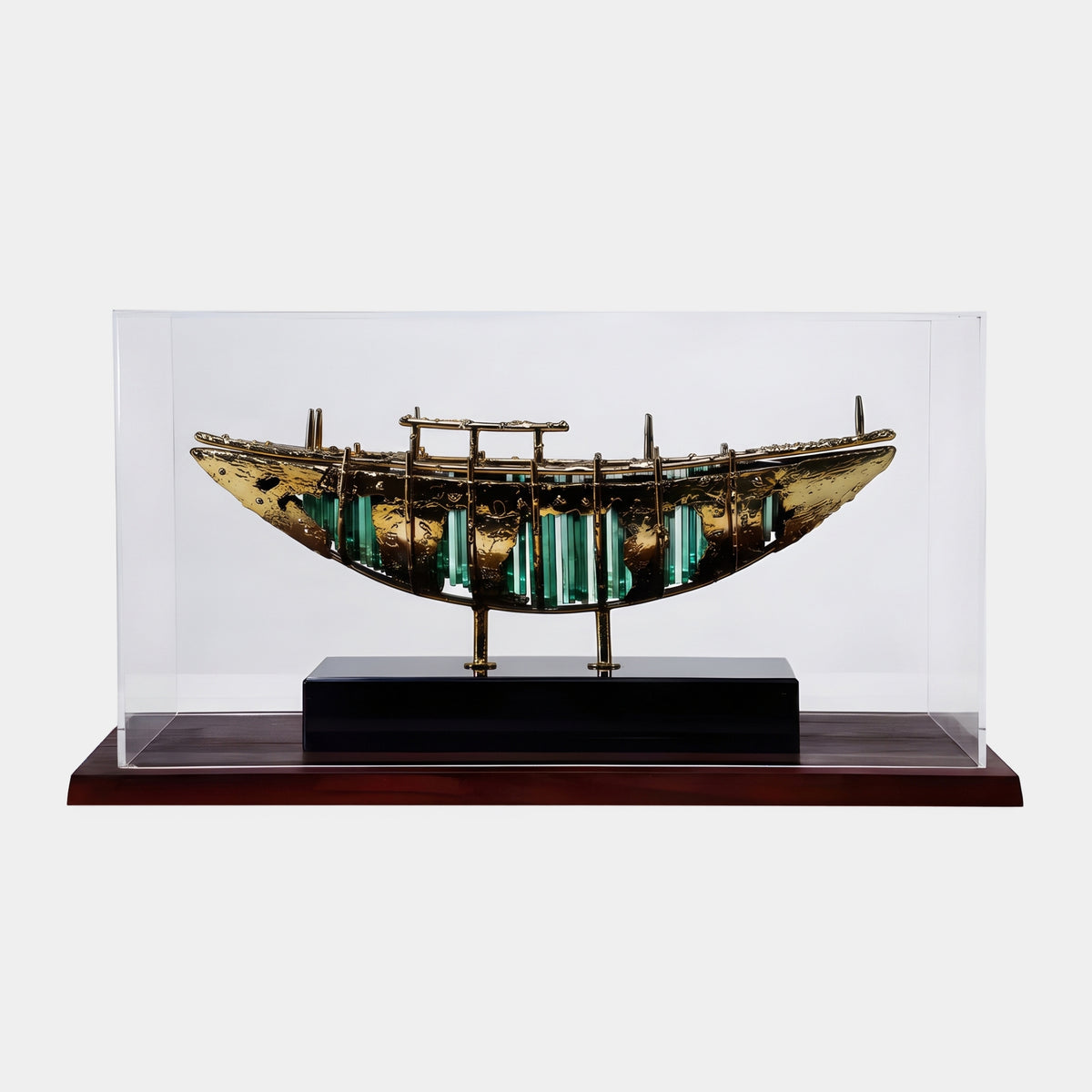 Gold & Green Cased Boat Metal Sculpture - 65cm, a gold-toned metal hull with green acrylic bars between ribs, on a black and wood base under a clear display case, plain white background.