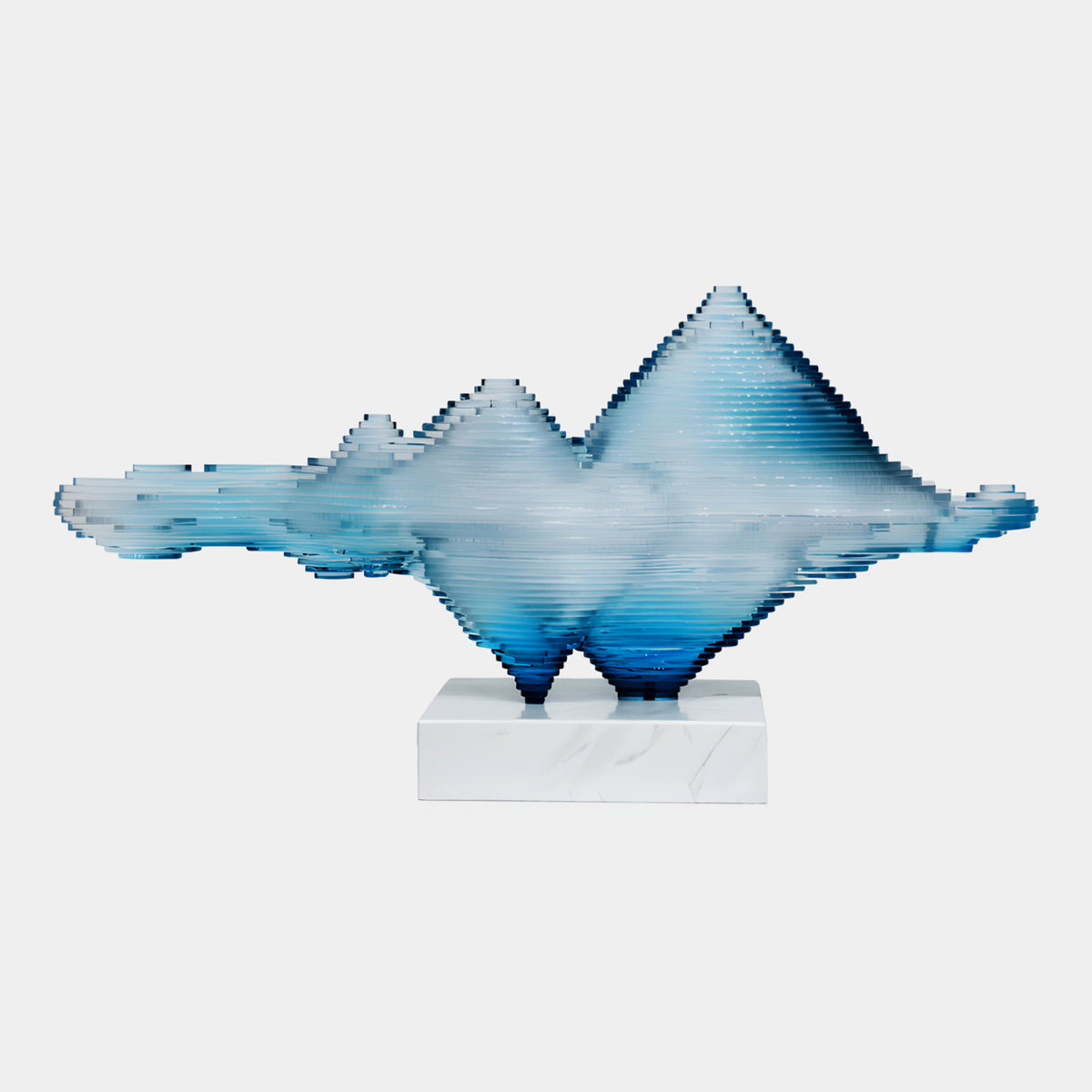 Blue Stepped Mountain Range Acrylic Sculpture - 65cm, layered acrylic peaks in blue tones on a white marble base, shown against a plain light background.