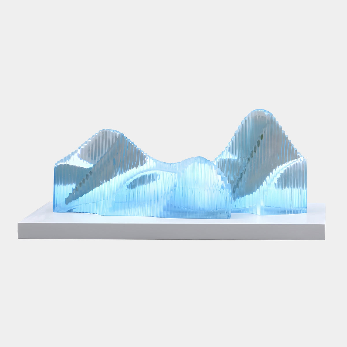 Blue Finned Mountain Range Cast Resin Sculpture - 90cm, translucent blue vertical fins forming two peaks on a white marble base, plain light background.