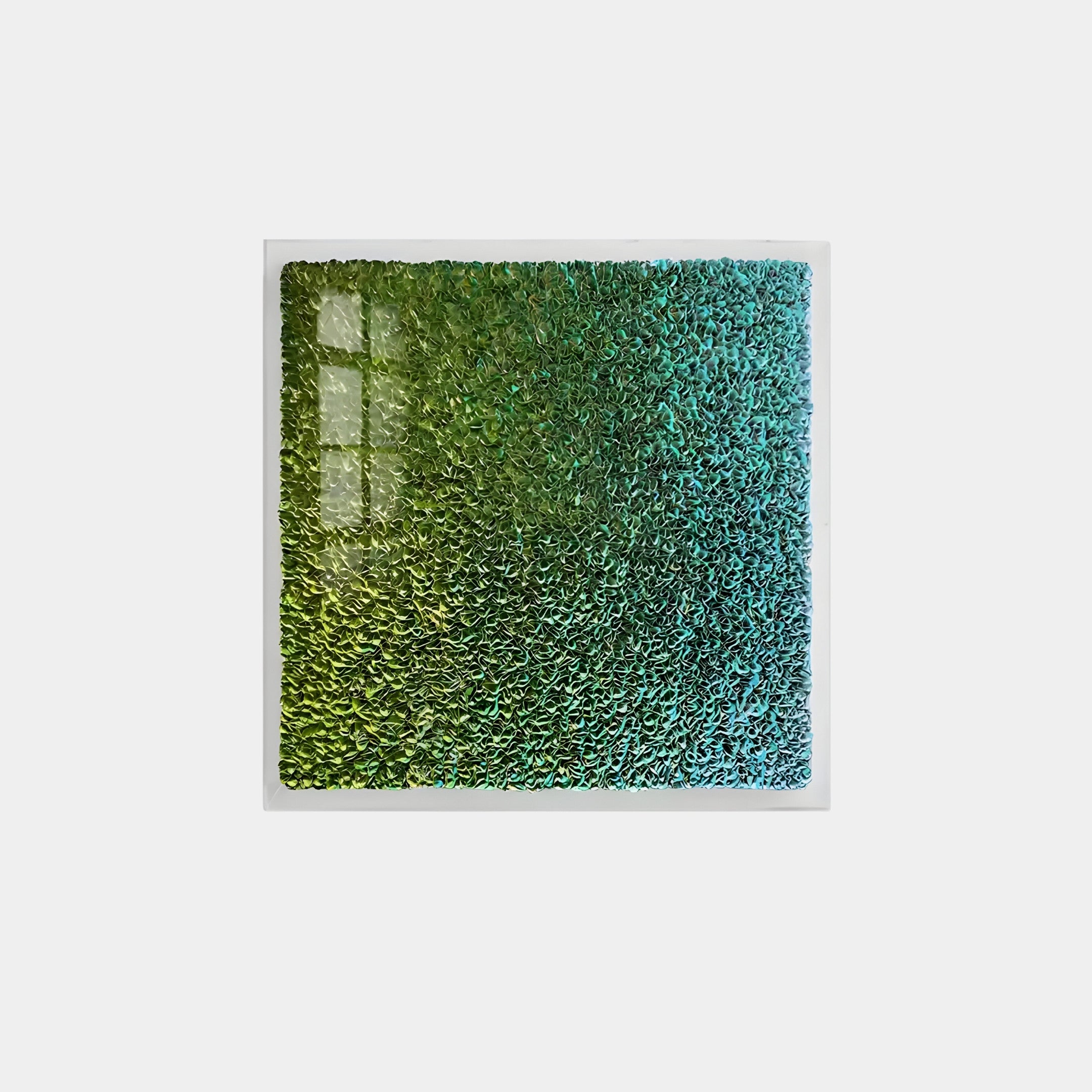 The Chromatica Square Lush Green Gradient Paper 3D Wall Art by Giant Sculptures features a square design with a textured gradient from green to teal. Its wavy surface catches the light, creating a shimmering effect ideal for spaces seeking unique decor.