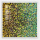 The Chromatica Square Vibrant Green Rolled Paper 3D Wall Art by Giant Sculptures features tightly packed rolled paper tubes in vibrant greens, yellows, and blues, creating a striking textured mosaic perfect for adding color and depth to your space.