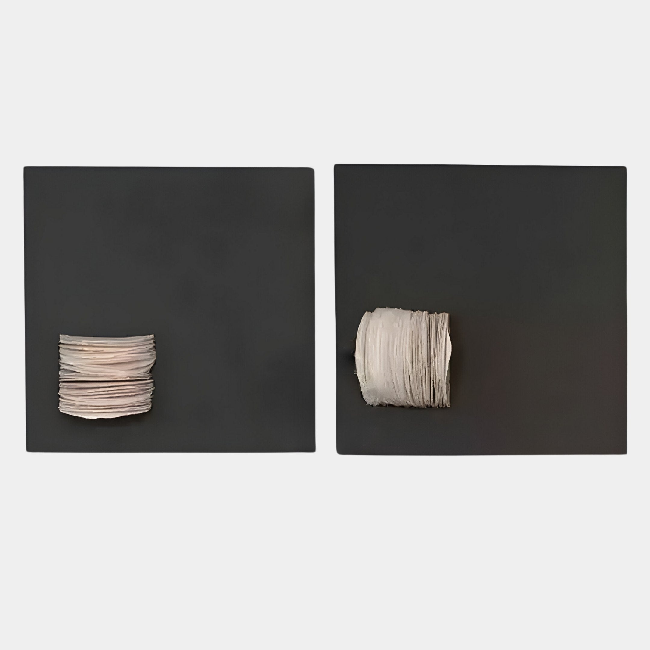 The Modulus Black & White Duo Panel Abstract Wall Art by Giant Sculptures features two black square panels, each displaying a sleek stack of white discs—an elegant, contemporary piece with a subtle wabi-sabi touch.