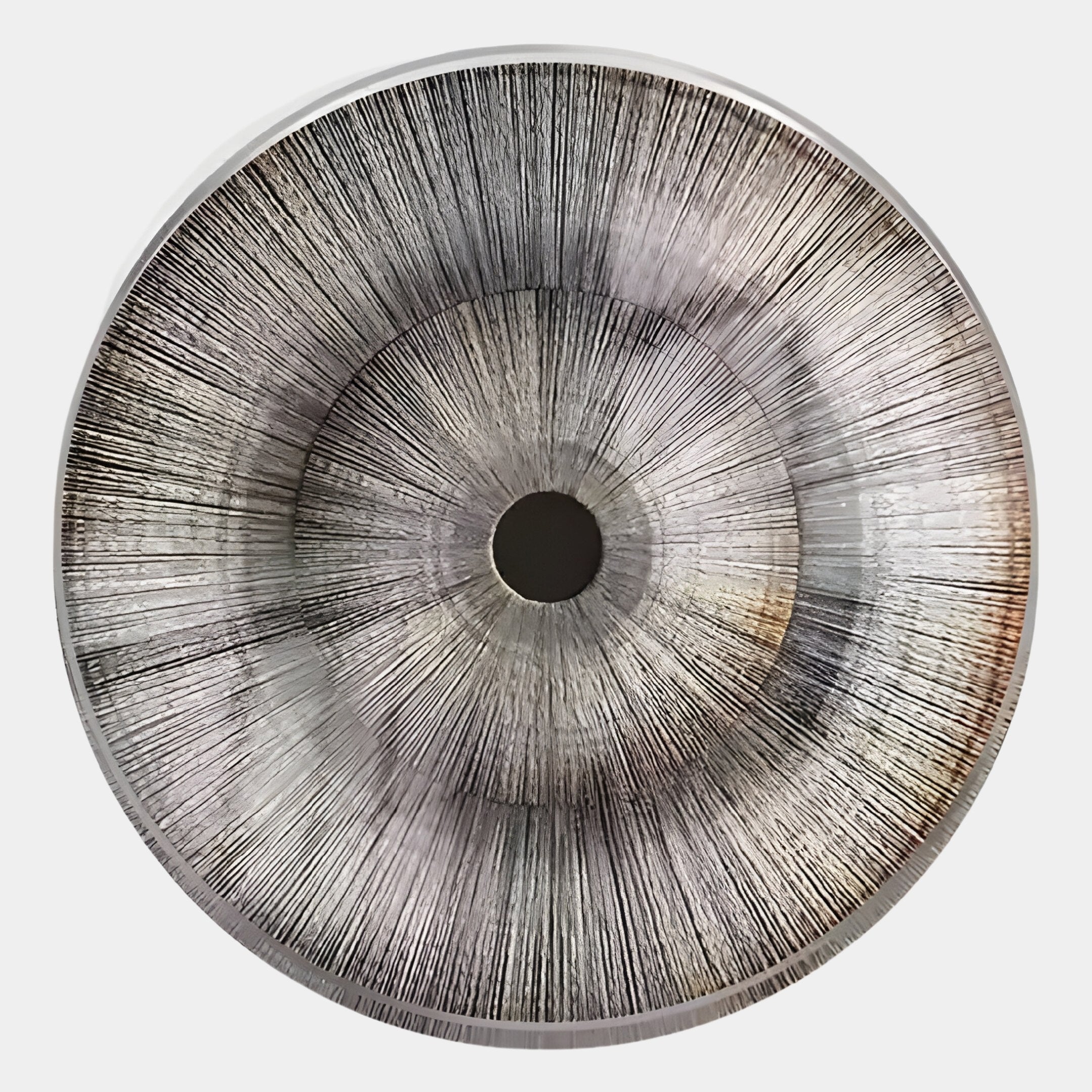 The Oculis Warm Neutral Circular Handmade 3D Paper Wall Art from Giant Sculptures features a metallic finish, central black detail, and radiating lines for an elegant sunburst pattern on a silver-gray background.