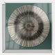 Oculis Emerald Horizon Square Handmade 3D Paper Wall Art by Giant Sculptures features radiating black and silver lines on a soft green backdrop, mounted in acrylic with a central hole, creating a bold geometric pattern.