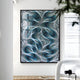 In a modern, bright room, the Giant Sculptures Filigree Turquoise Swirl Quilling Paper Wall Art decorates the wall. A small camera sits on a white table nearby, while a stack of books lies on the light wood floor. The artworks plexiglass cover beautifully catches the light.