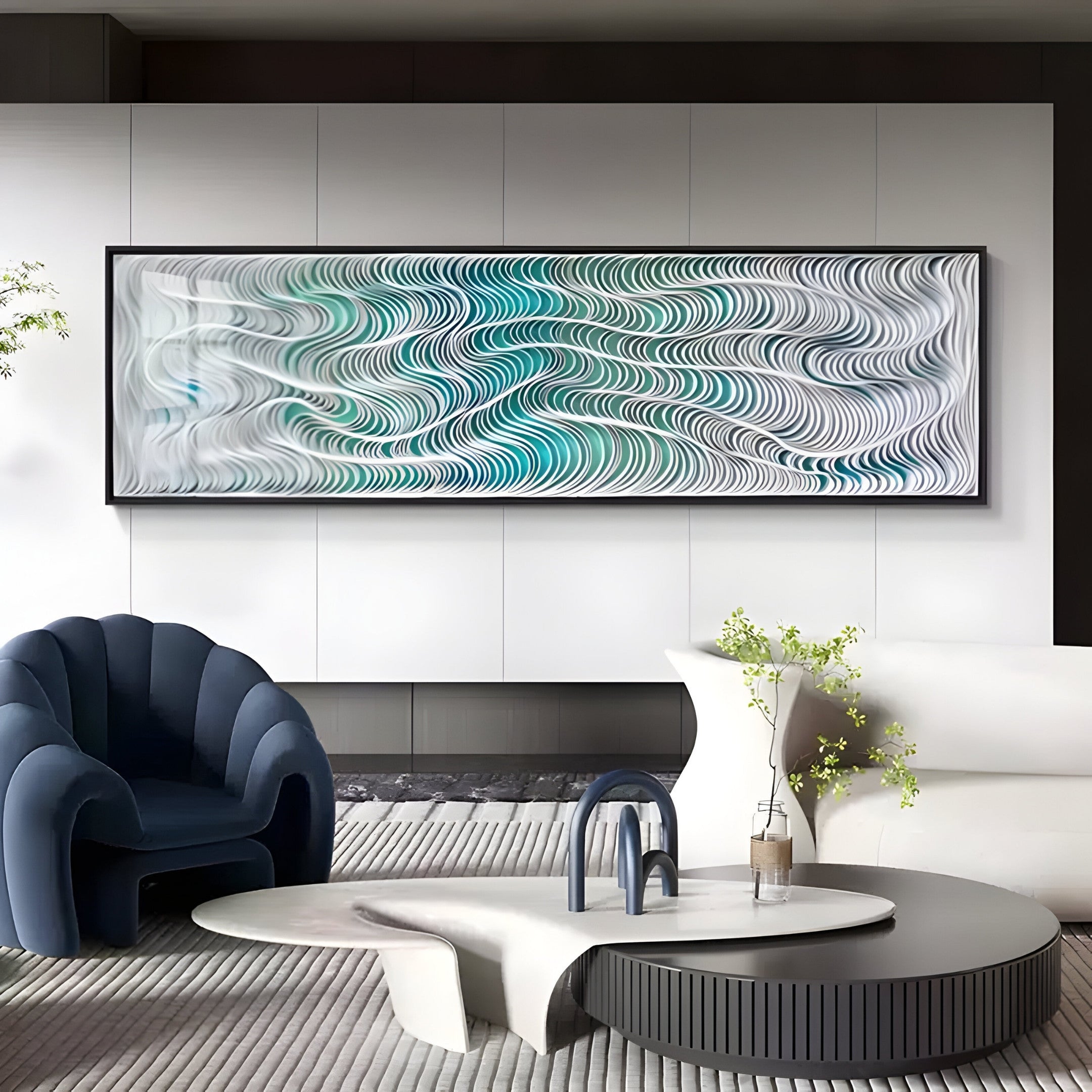 A modern living room channels a coastal vibe with the Fluenta Aqua Ripple Linear Cardboard 3D Wall Art by Giant Sculptures, featuring wave patterns in blue and white. The space includes a navy armchair, round coffee table with a vase, and gray rug against a neutral wall.