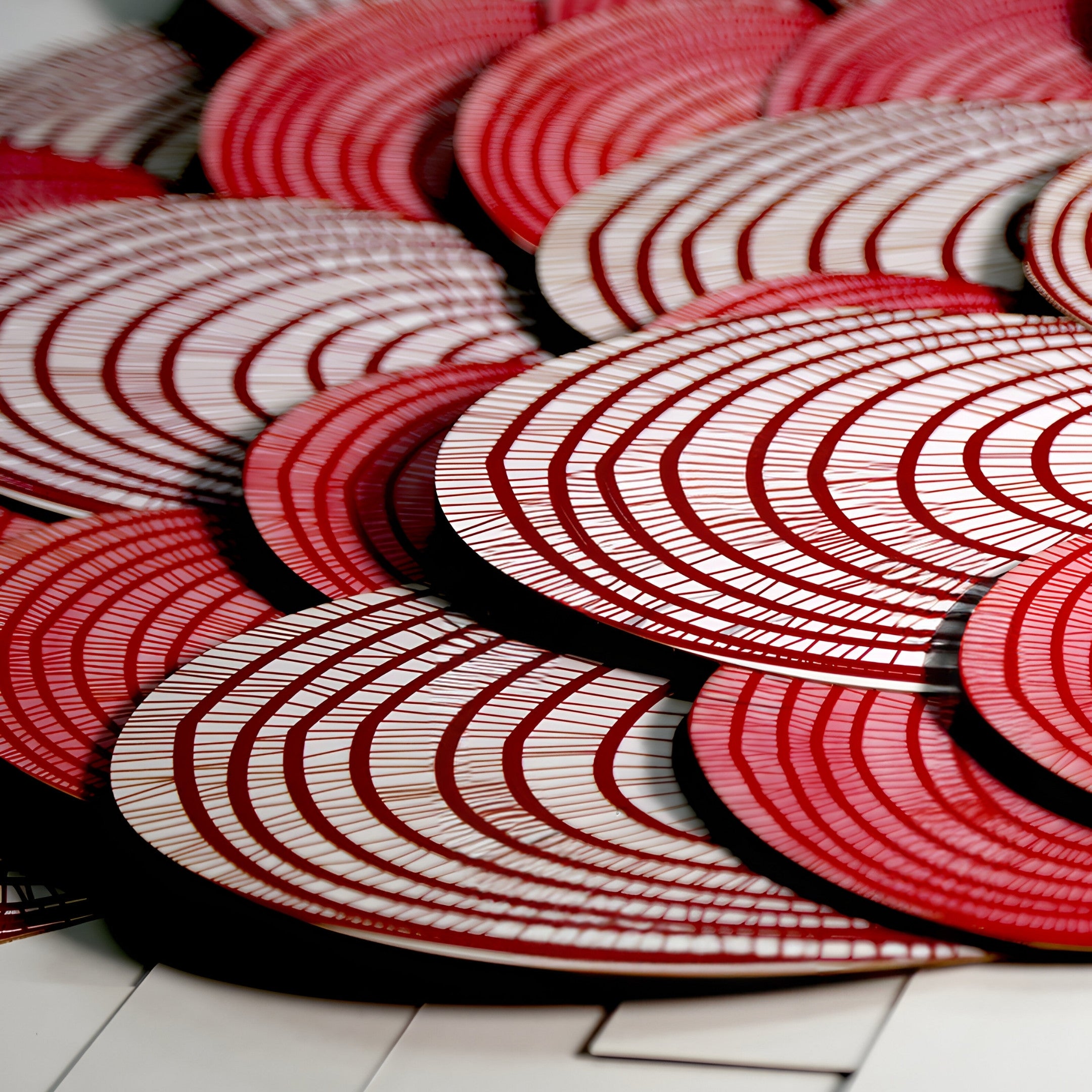 The Rosette I Vibrant Red Circular Pattern Wall Art by Giant Sculptures displays overlapping red and white circular designs with concentric lines on a smooth surface, creating an abstract, three-dimensional effect reminiscent of fortune wall art.