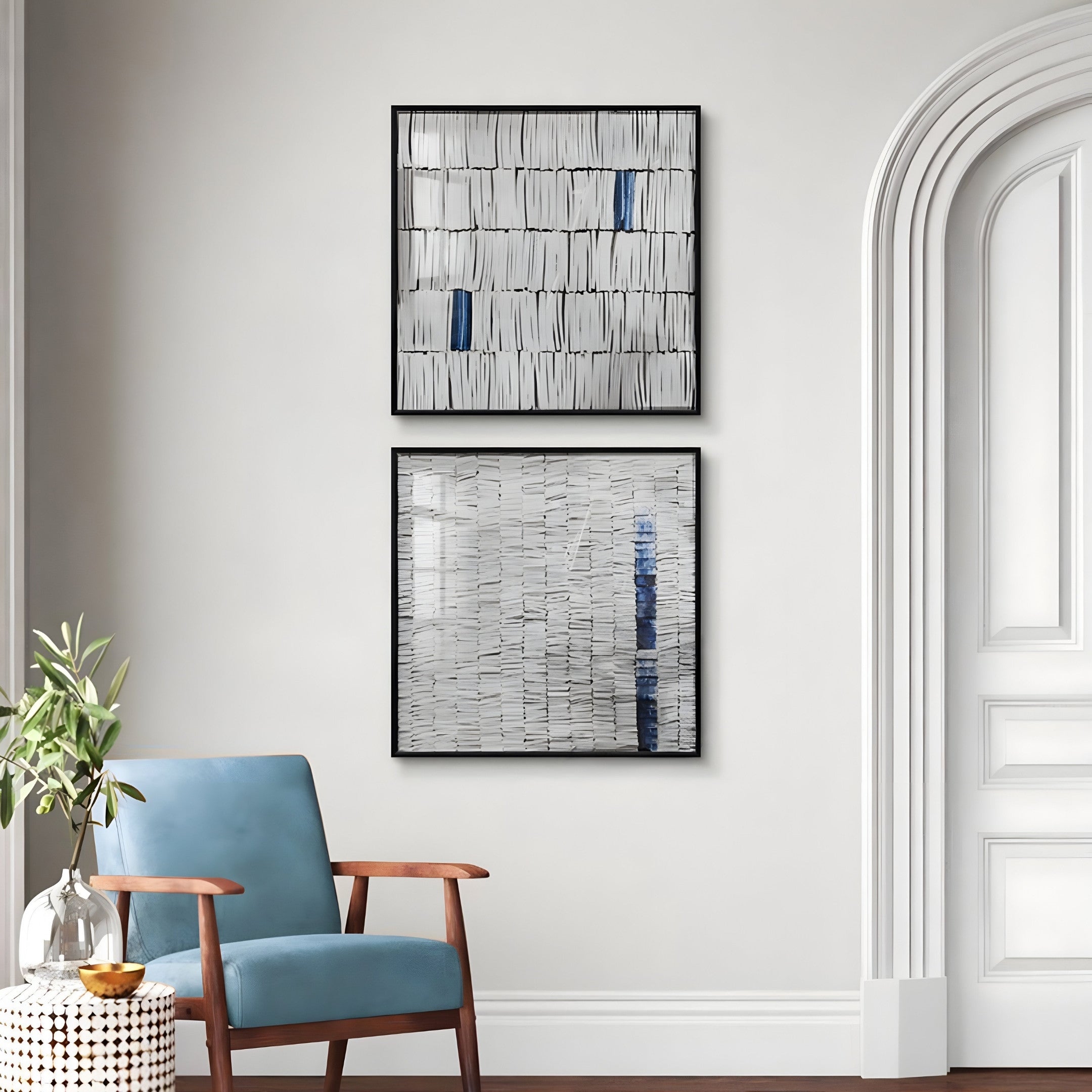 A stylish living room features a wooden armchair with blue upholstery against white walls adorned with Giant Sculptures Tracery II Blue & White Textured Paper Wall Art. A potted plant complements the scene on wooden flooring, completing this contemporary home decor.