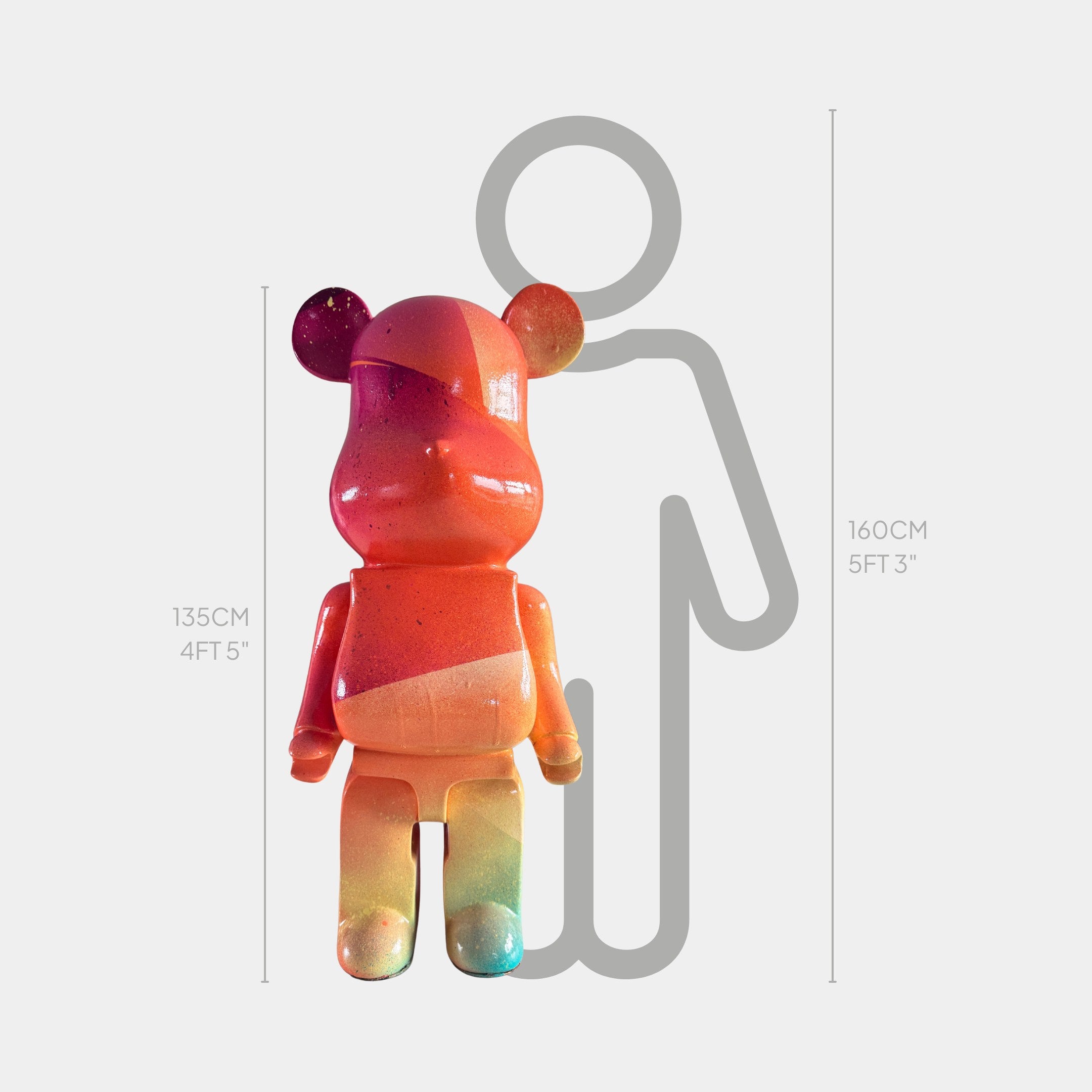 A vibrant Candy Bear Sculpture - 135cm by Giant Sculptures is displayed beside a gray human outline for scale. The limited edition bear stands 135 cm tall; the outline measures 160 cm (5 ft 3 in).