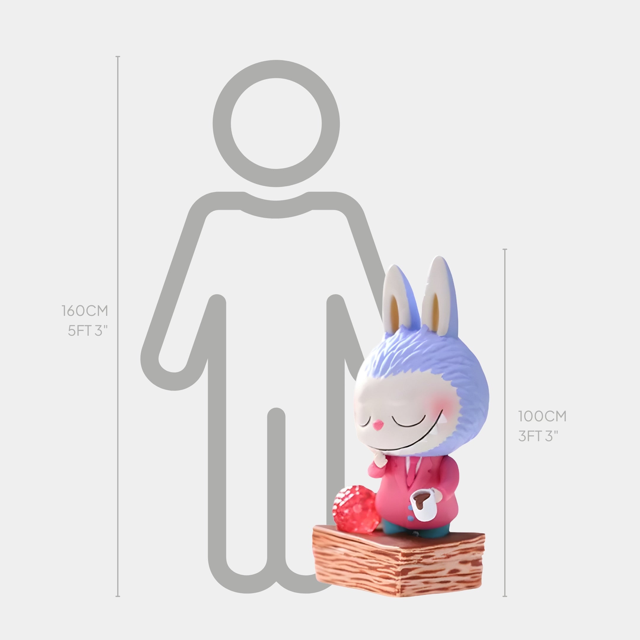 The Sweet Mischief Napoleon Slice Labubu Sculpture by Giant Sculptures is a 100 cm cartoonish blue-furred figure in a pink suit, standing on a wooden block with a strawberry, shown next to a 160 cm human for scale.