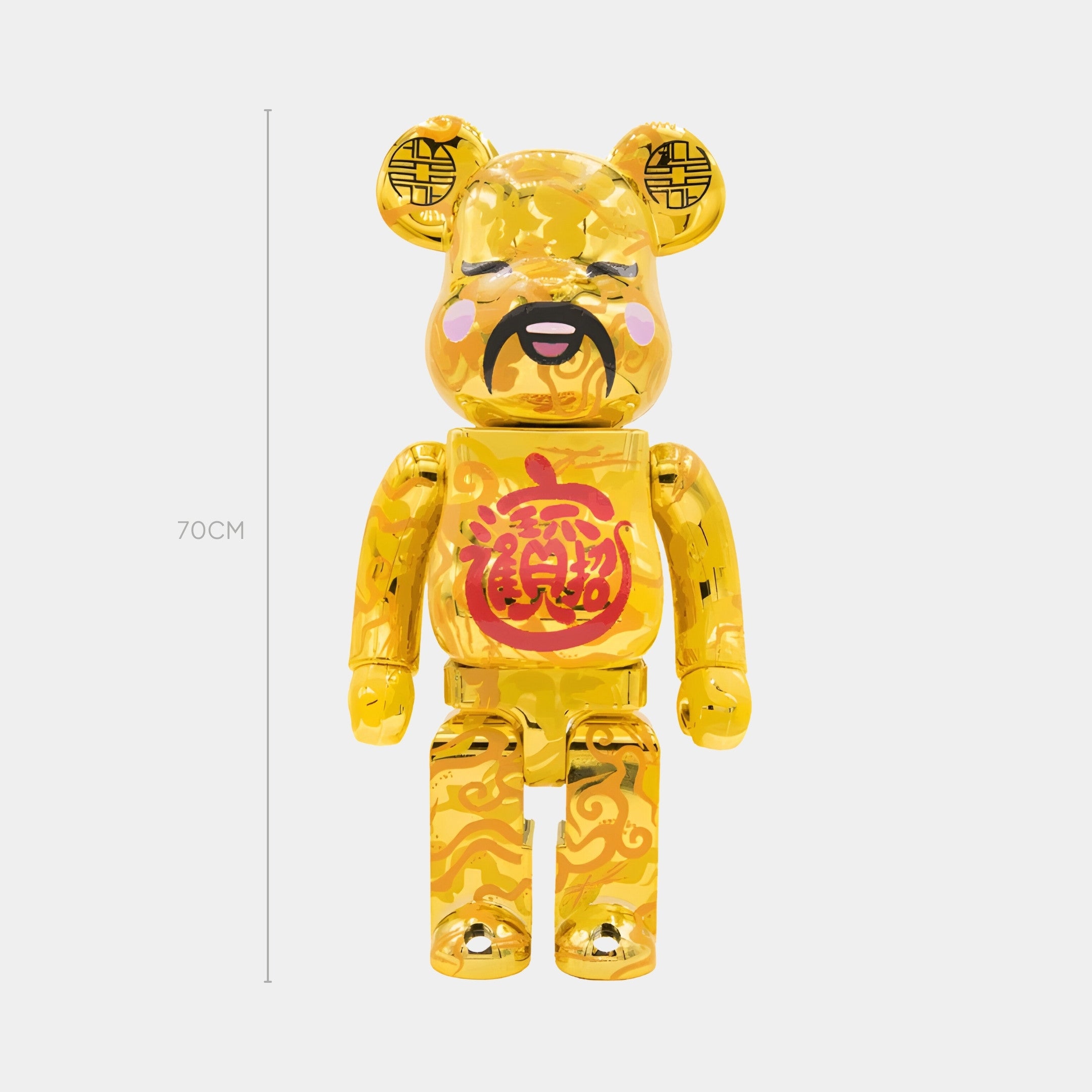 The Chinese Charm Gold Bear Sculpture - 70cm by Giant Sculptures features a gold bear with a mustache, pink cheeks, and ornate patterns, showcasing a bold red Good Fortune character on its chest and detailed designs across its head and body.
