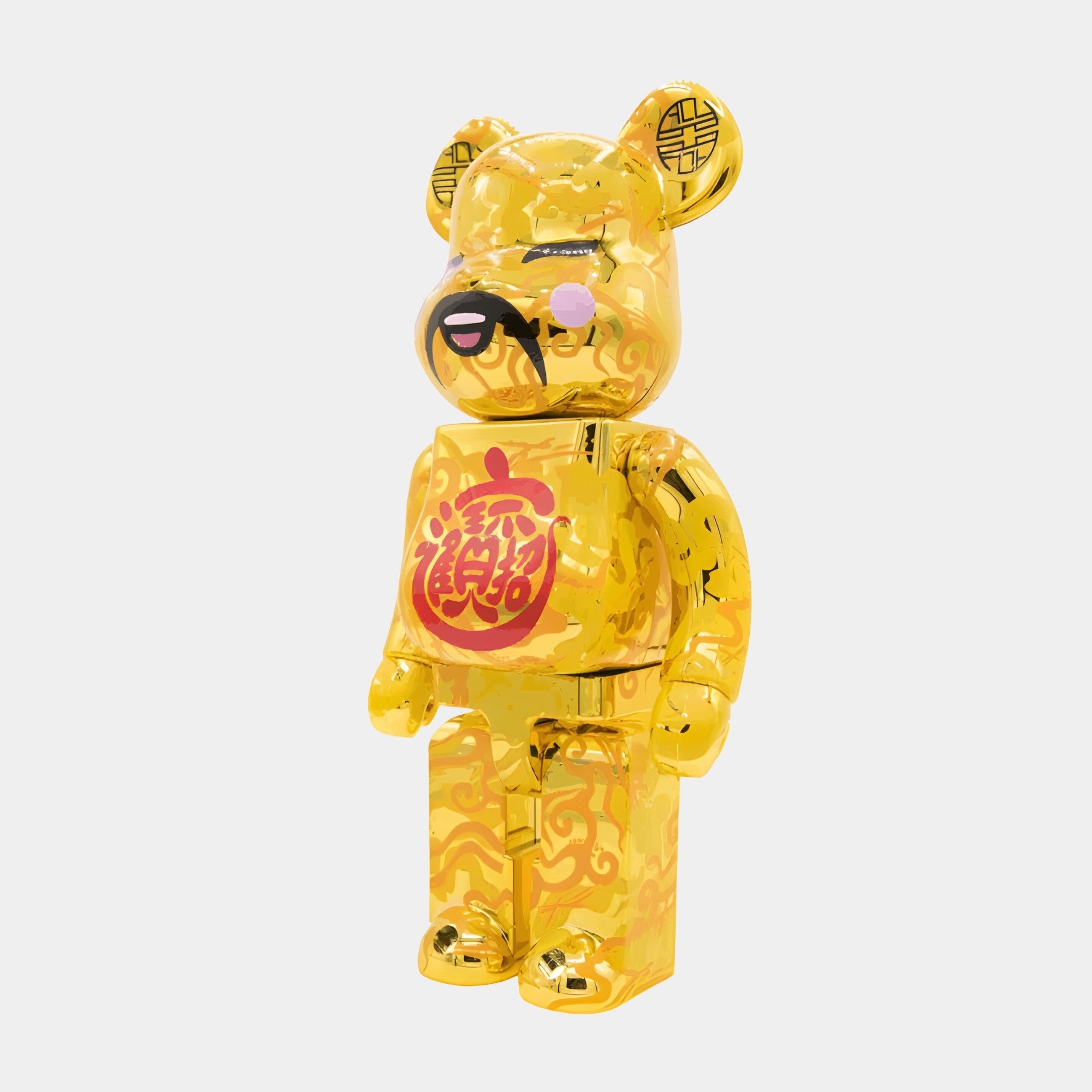 The Chinese Charm Gold Bear Sculpture - 70cm by Giant Sculptures stands upright with an intricate pattern, pink cheeks, and Chinese characters on its chest, symbolizing good fortune and Chinese charm against a white background.