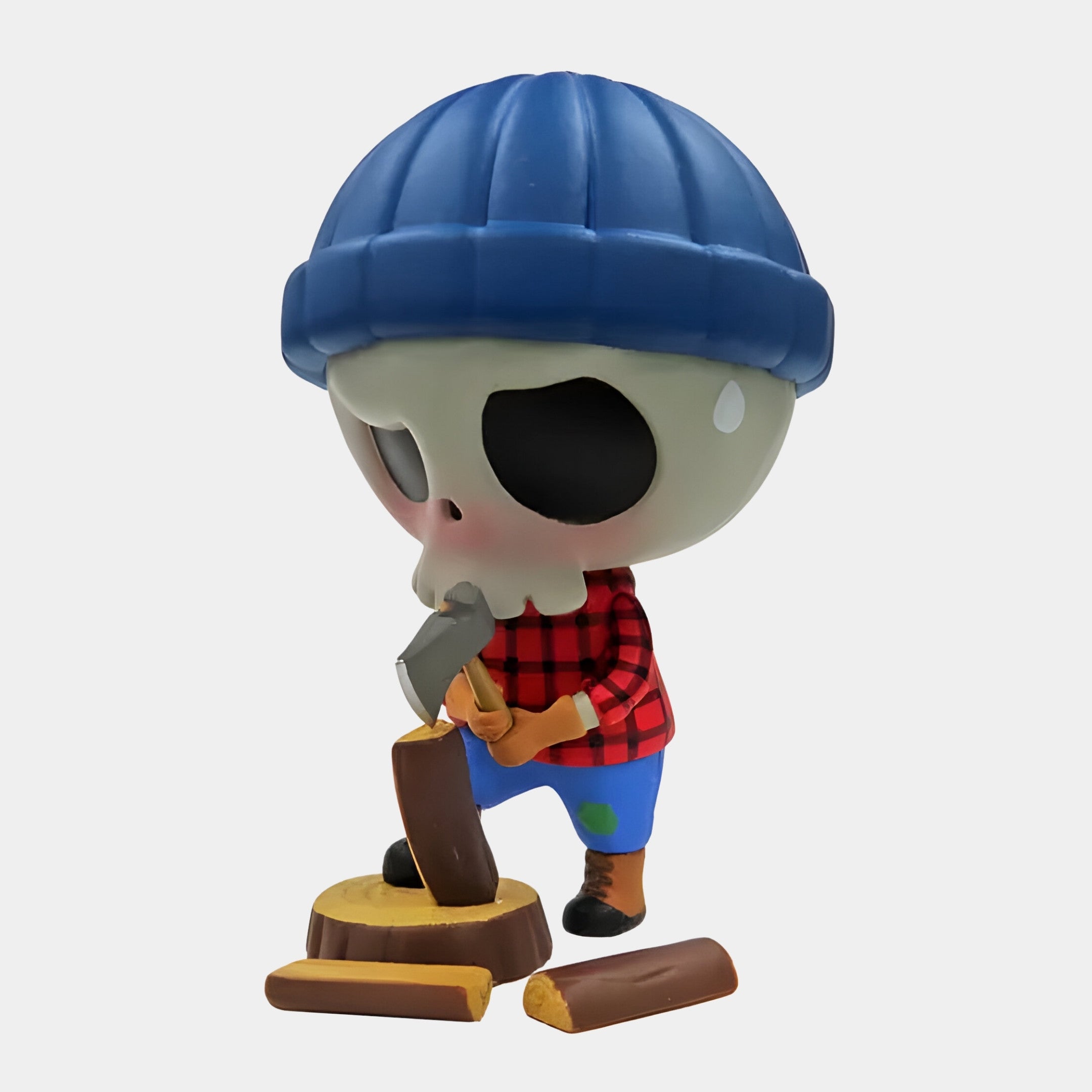 The Camp Life Lumberjack Skull Labubu Sculpture by Giant Sculptures stands 160cm tall, featuring a skull face, blue beanie, red plaid shirt, and blue pants, chopping wood with scattered logs—ideal for unique indoor display.