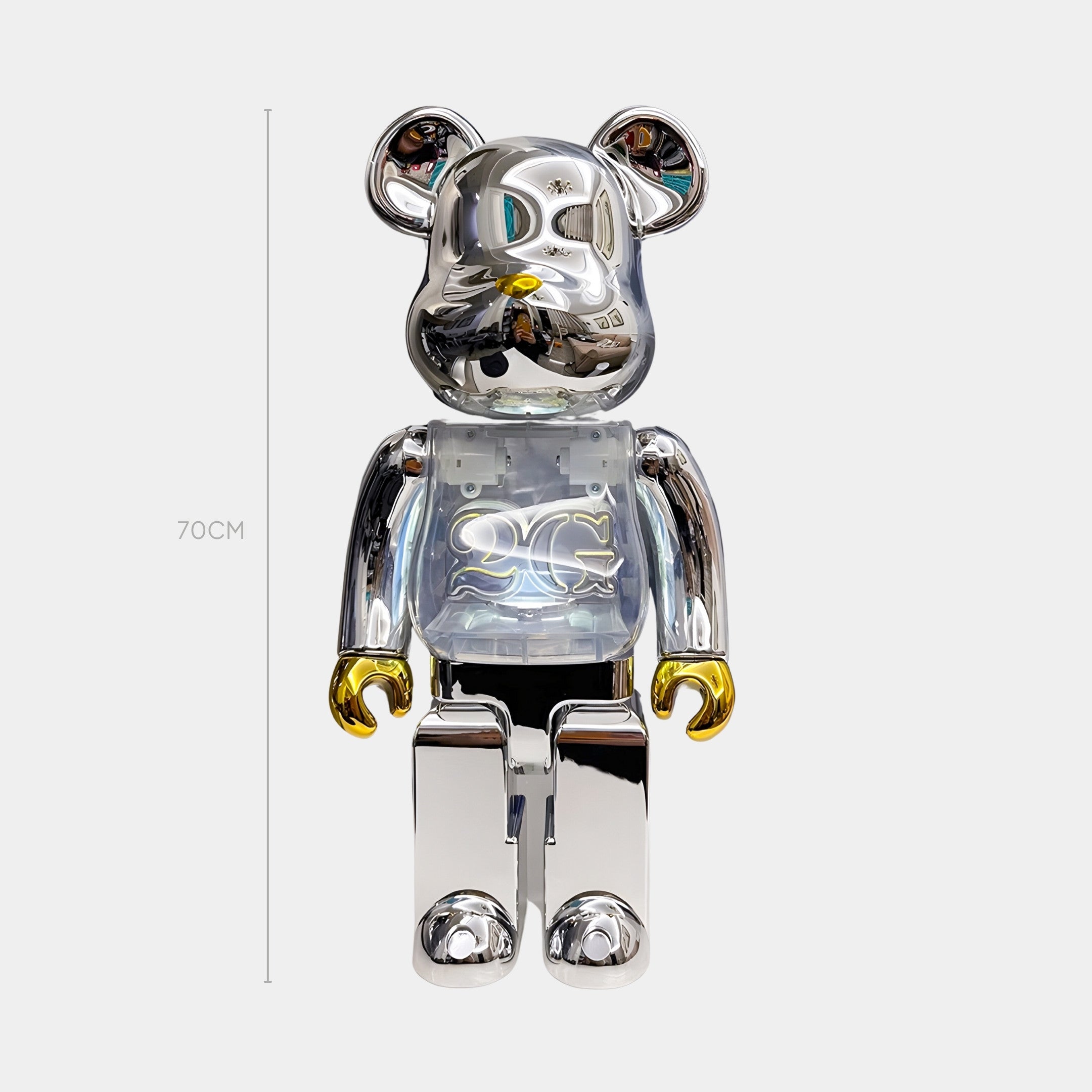 The Nexus Chrome Bear Sculpture by Giant Sculptures stands 70cm tall, featuring a shiny silver finish, gold-tipped ears and hands, and a transparent chest with a decorative pattern for a striking, limited edition display.