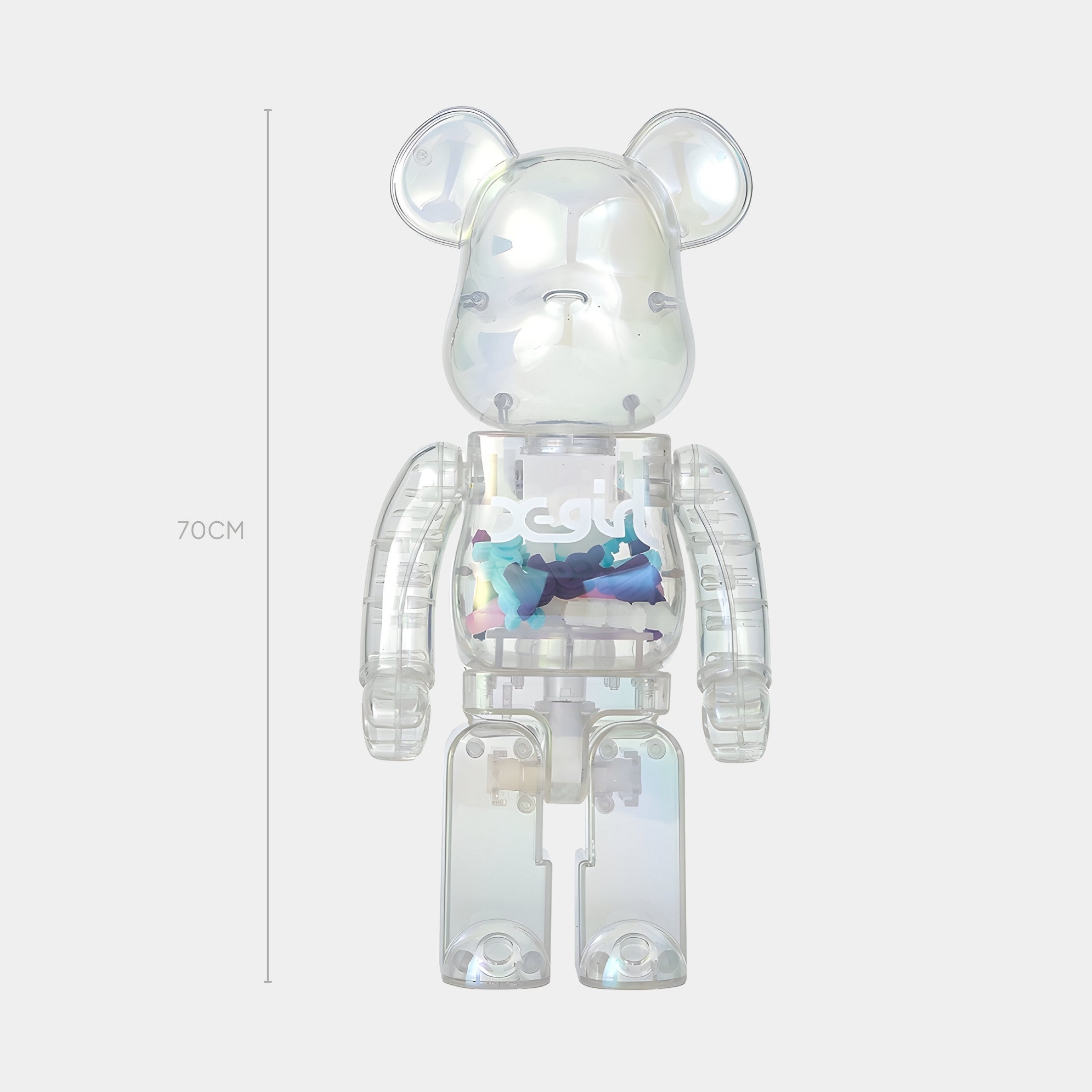 The Giant Sculptures Clear Mirage Bear Sculpture - 70cm features a transparent body filled with small colorful bears that shimmer with iridescent film, offering kinetic fun and standing upright against a plain light background.