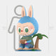 The Coconut Fruit Labubu Sculpture - 160cm by Giant Sculptures features a blue-eared, cartoon animal holding a bowl beside a mini palm tree, standing 160cm tall with a human silhouette for scale—a true tropical delight.