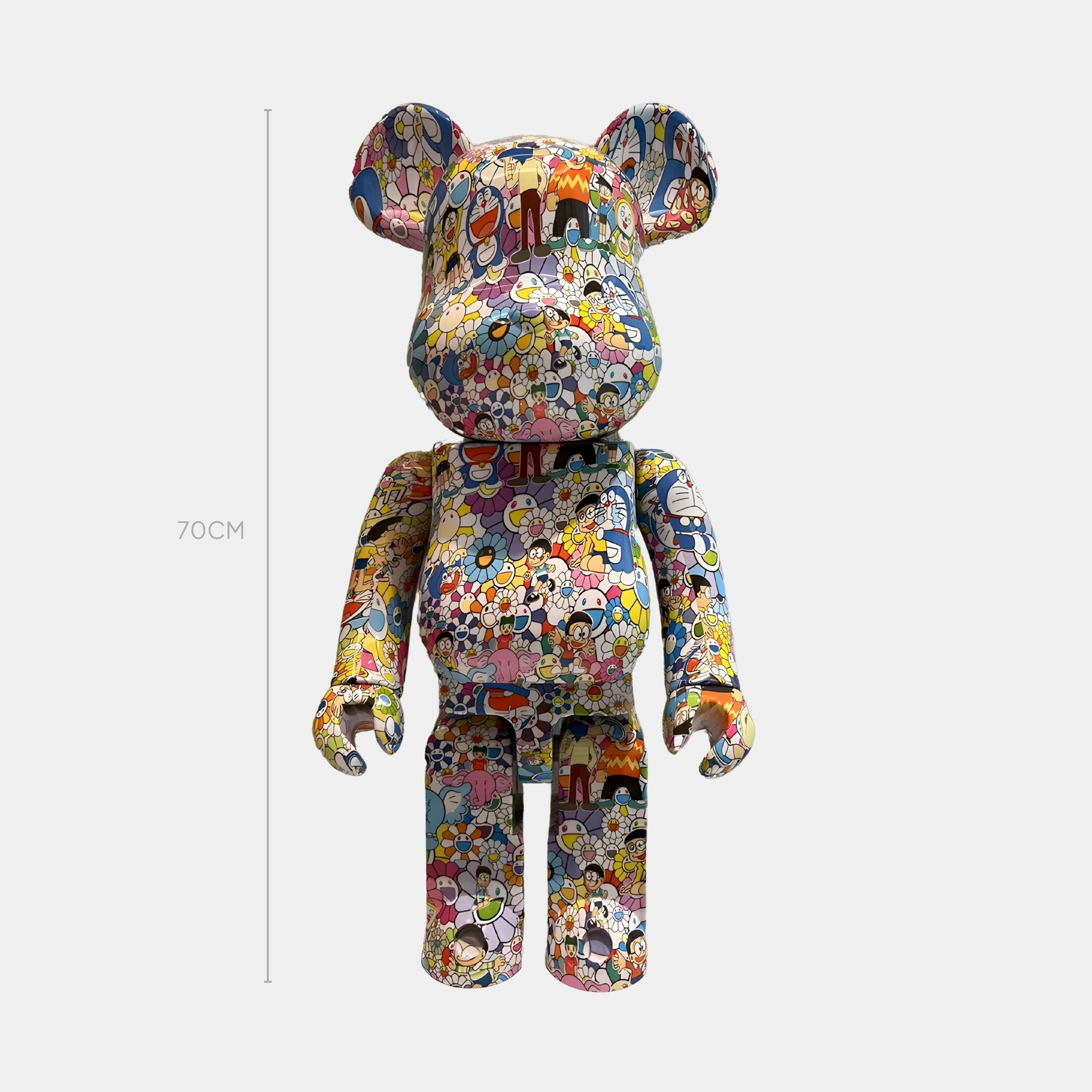 The Comic Wonder Bear Sculpture - 70cm by Giant Sculptures features a bear-shaped figure covered in vibrant cartoon and floral patterns, displayed against a plain white background.