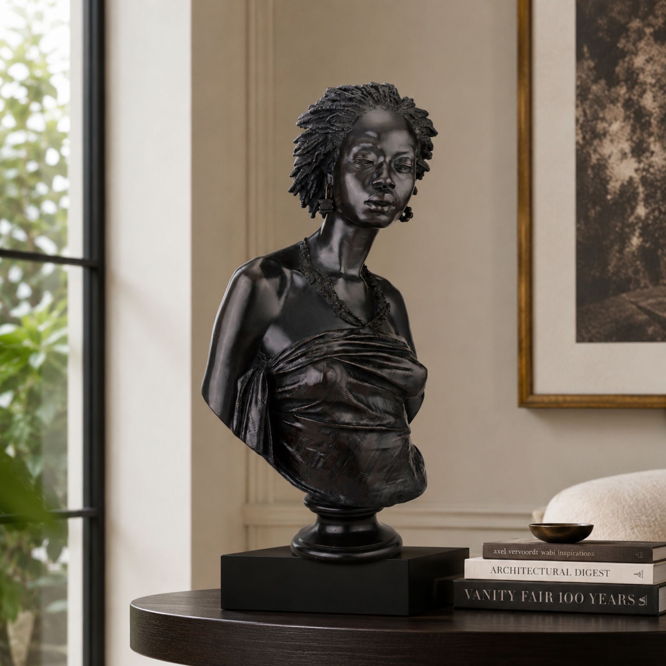 Classical African Woman Bronze Bust, 70cm, by Giant Sculptures, shown in black cast bronze on a dark pedestal atop a console table in a living room setting.